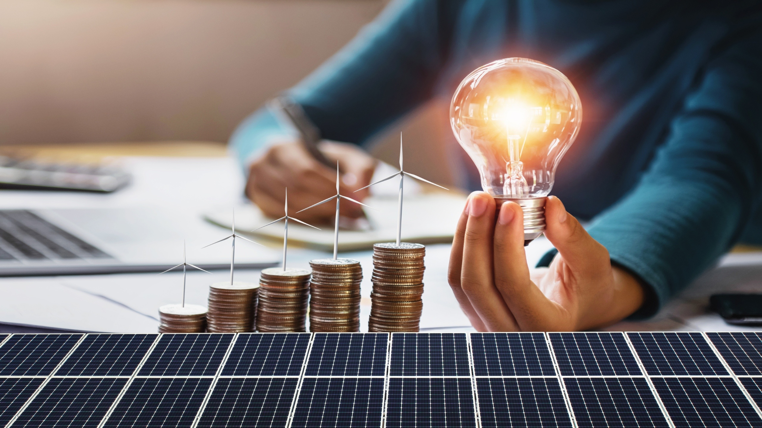 vecteezy businesswoman holding light bulb with turbine on coins and 8701060